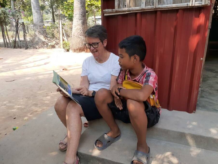 GENEROUS: Taksenkangbloung Community Centre co-found Jenny Burchell, of Warrnambool, reads to a student in Cambodia. 