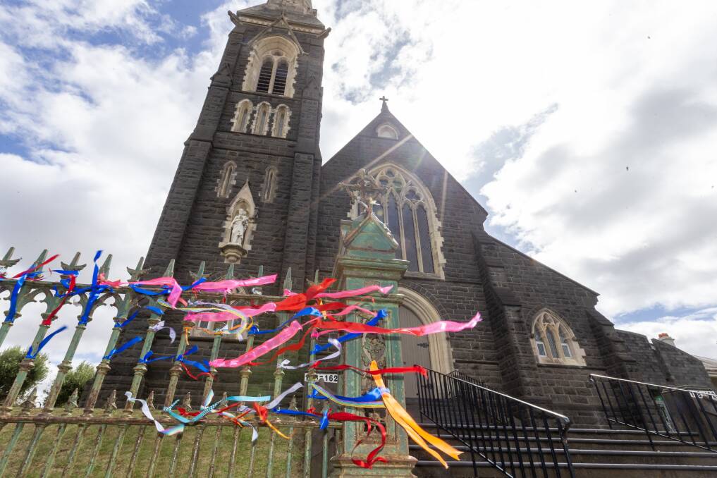 Ribbons adorn the fence of a Warrnambool church on the day of Pell's funeral.