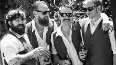 Robbie Morrow (right) enjoys a beer with mates.