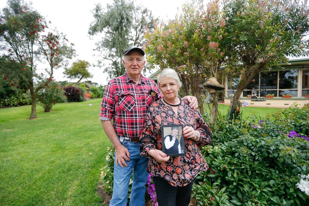 'SORELY MISSED': Lois and Herb Morrow with a photo of their son Robbie who was killed by a motorist in 2017. Robbie's work boots hang from a tree in the background. Picture: Anthony Brady