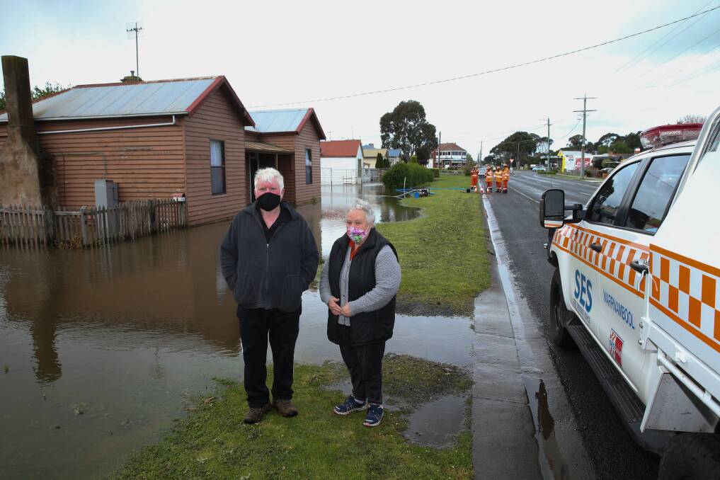 BIT DAMP: Allansford residents Owen and Carol McKenna outside their home which they can not access due to flooding. Picture: Mark Witte