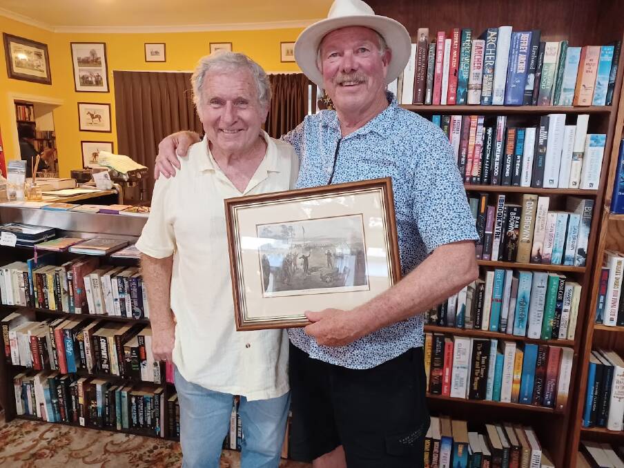 Bookworm Gallery owner Dennis Melbourne (left) with Eureka Stockade descendant Glenn Hearn and his prized lithograph of the event. Picture by Jenny McLaren