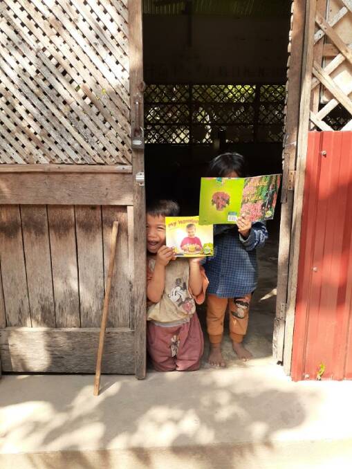 HAPPY: Children in Taksenkangbloung village enjoy reading. 