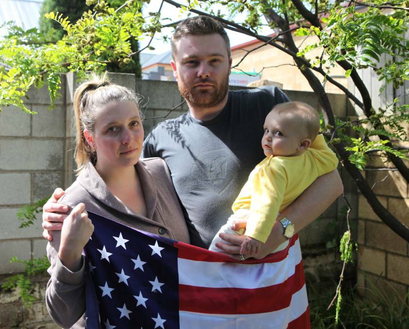 SAD OLD FLAG: Katlynn Neill, pictured with her husband Ben and daughter Aria, said she is ashamed to be American following the election result. Picture: Matt Neal
