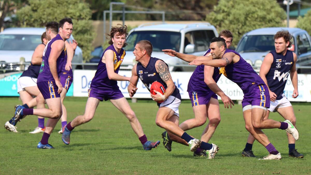 SURROUNDED: Warrnambool's Jason Rowan evades Port Fairy opponents on Saturday. Picture: Justine McCullagh-Beasy 