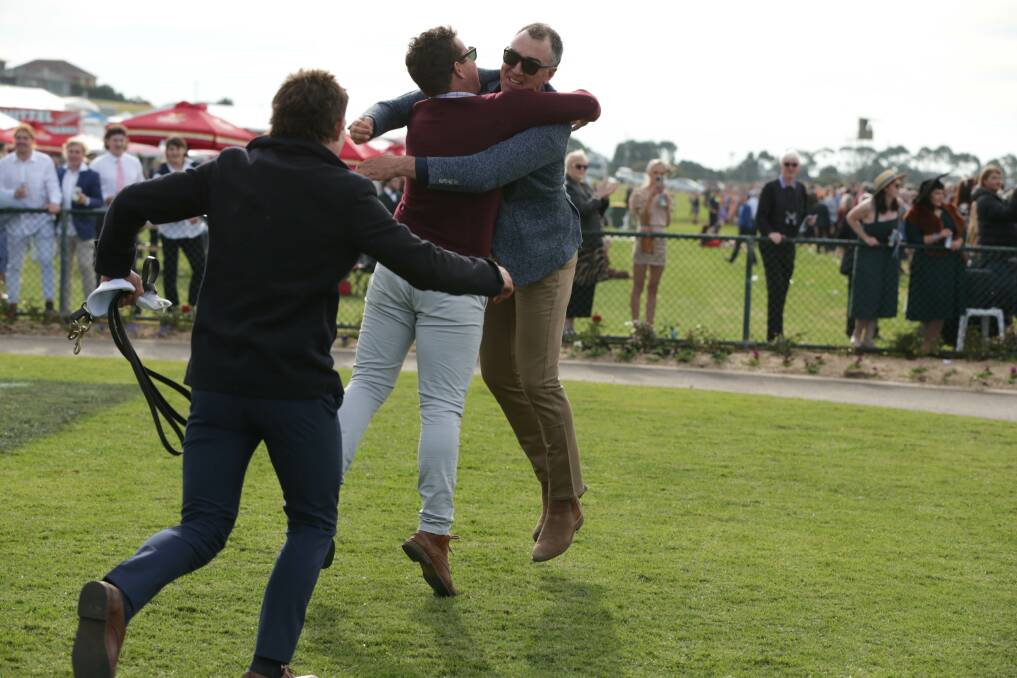 WINNING FEELING: Liam Hoy and Symon Wilde celebrate Gold Medals' remarkable victory in the Grand Annual Steeplechase. Picture: Chris Doheny 