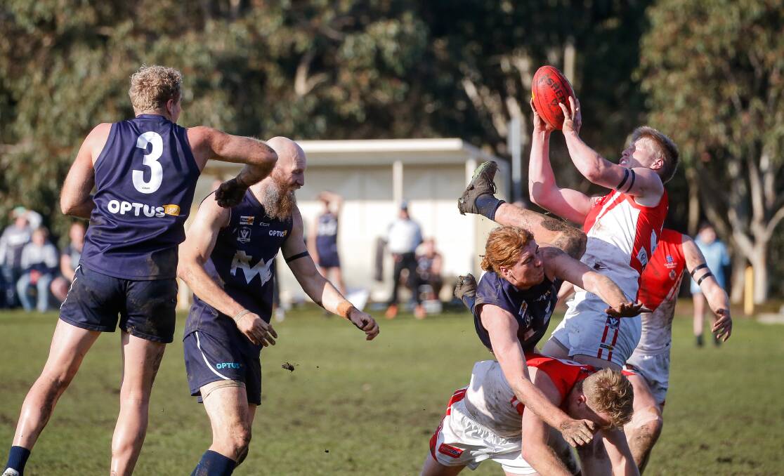 CRUNCH: Bodies collide as Tim Ryan takes a strong mark for South Warrnambool. Picture: Anthony Brady 