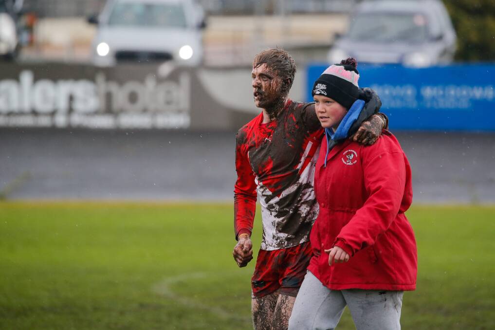 HURT: South Warrnambool's Harry Lee is helped off the ground in the opening term. Picture: Anthony Brady 