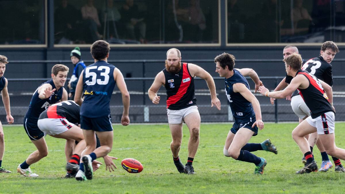 Cobden's Louis Cahill (centre) prepares to pounce on a loose ball against Warrnambool during the 2023 Hampden league season. Picture by Anthony Brady