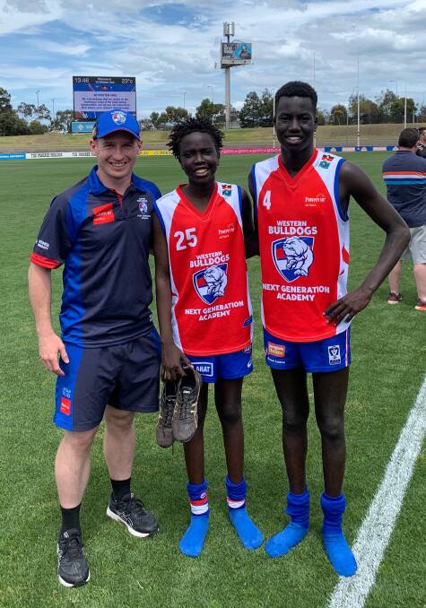 SCHOOL PRIDE: Emmanuel College teacher Ben Walsh and students Pwoch Akoch and Luamon Lual were part of a Western Bulldogs' NGA team. 