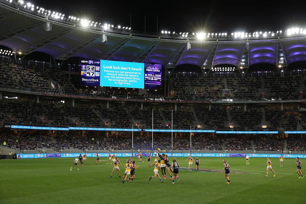 FAN-TASTIC: More than 25,000 supporters watched Fremantle and West Coast play in Western Derby 51 at Optus Stadium on Sunday night. It was a step forward after coronavirus restrictions forced fans out earlier this season. Picture: Getty Images 