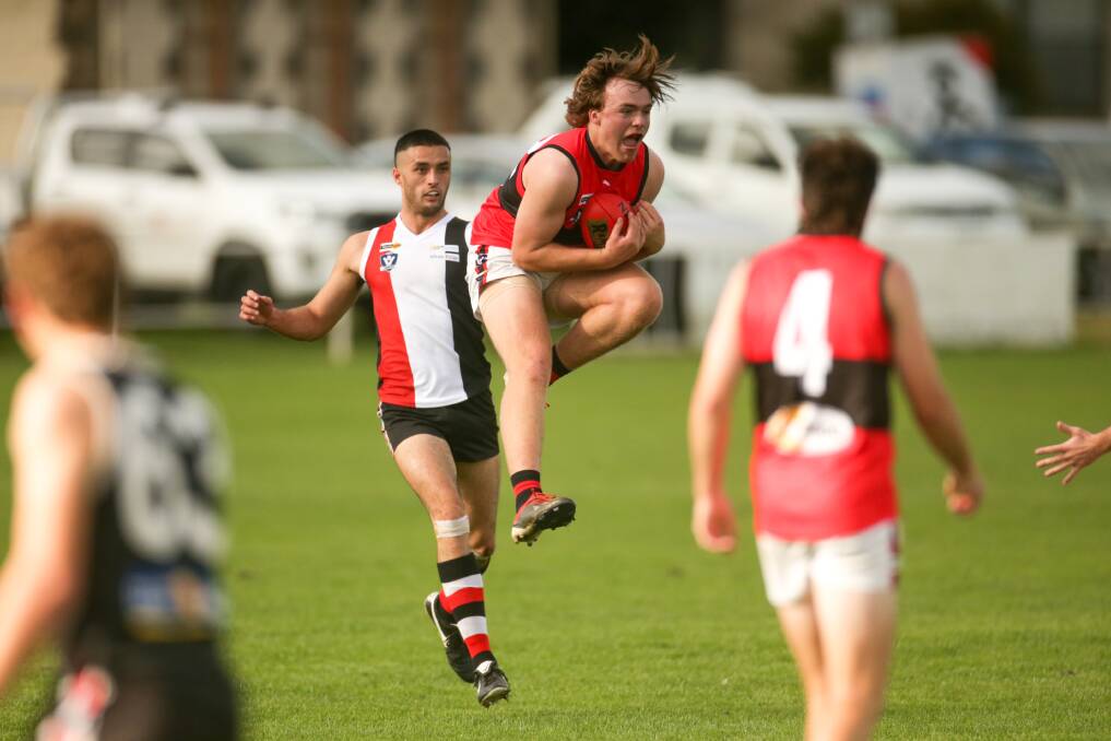 AIR TIME: Cobden's Tyler Humphrey takes a mark in front of Koroit's Jarrod Korewha. Picture: Chris Doheny 