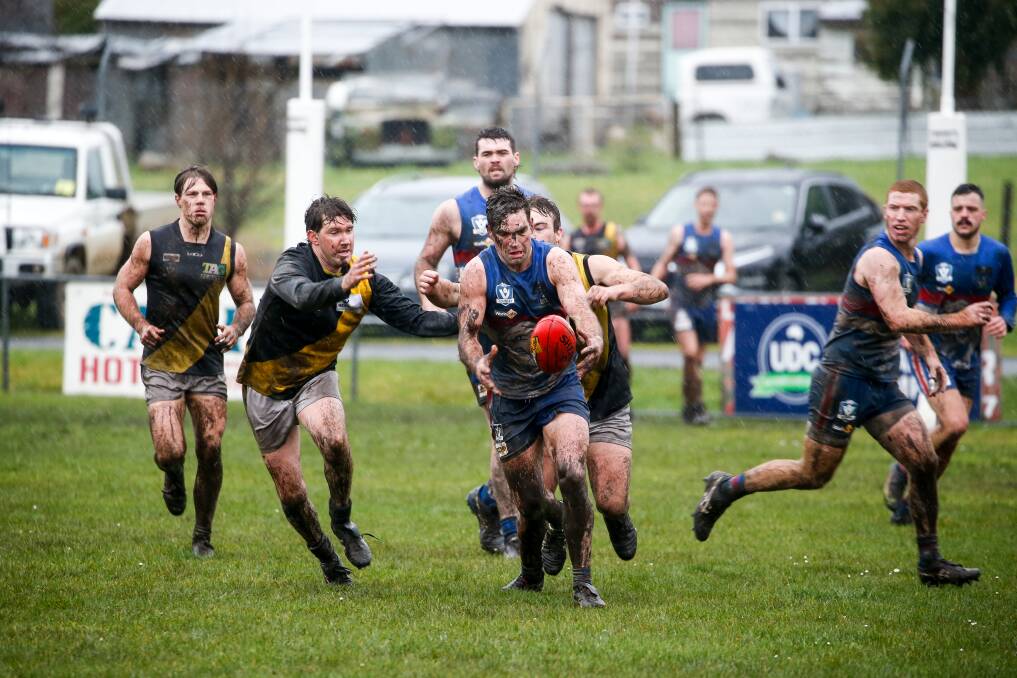 RAIN, RAIN GO AWAY: Panmure's Tom Wright tries to get boot to ball quickly during a wet game against Merrivale. Picture: Anthony Brady
