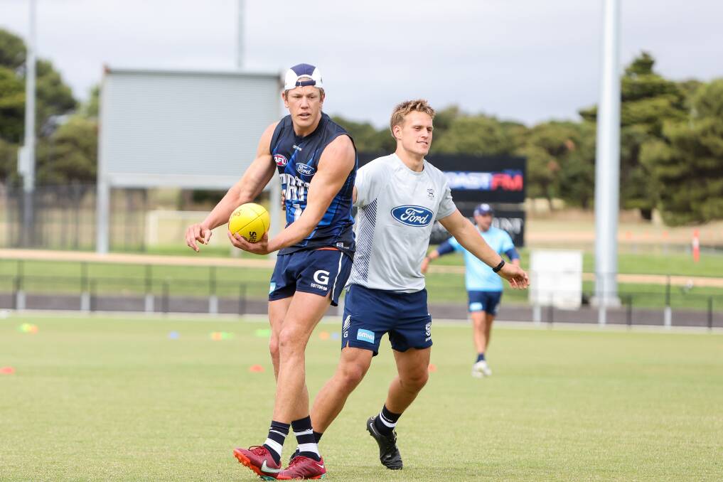 Geelong ruckman Rhys Stanley is manned by South Warrnambool's George Stevens during Cats' training at Reid Oval. Picture by Anthony Brady 