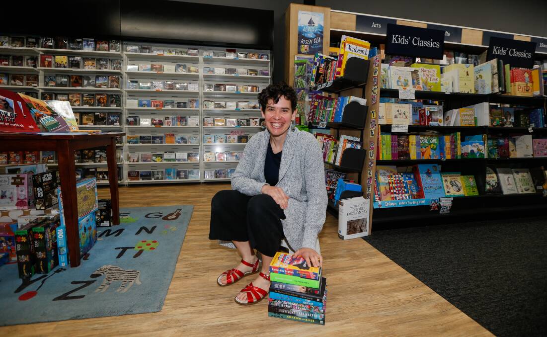 BOOK TIPS: Collins Booksellers' Sally Jane with some of the store's recommended reads. Picture: Anthony Brady 