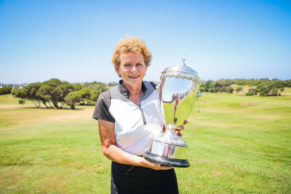 Betty Holscher with the Peter Thomson Cup which bears the names of past Warrnambool Golf Club Legacy Day winners. Picture by Anthony Brady 