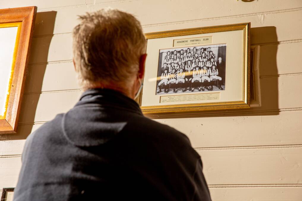 REFLECTIONS: Bob McCosh casts an eye over the 1972 Grassmere premiership team photo. Picture: Chris Doheny 