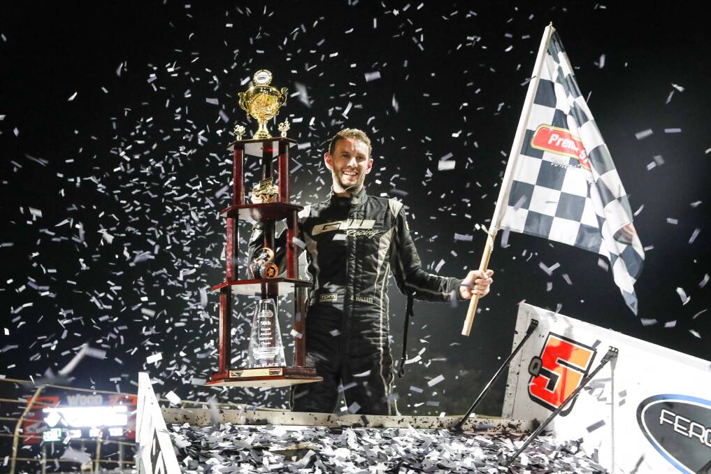 Brock Hallett with the spoils of his Grand Annual Sprintcar Classic triumph. Picture by Sean McKenna 