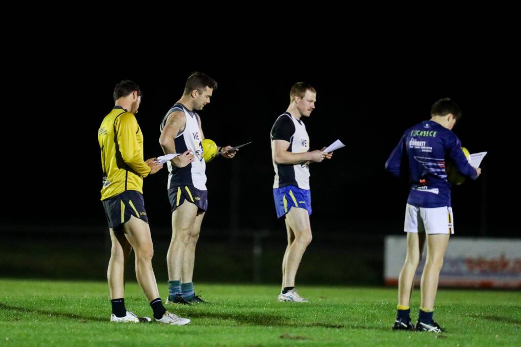 HOMEWORK: North Warrnambool Eagles players read instructions surrounding training in a COVID-19 environment. Picture: Morgan Hancock 