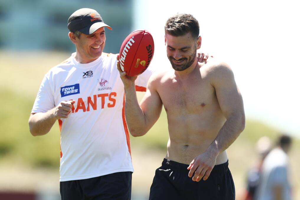 HAPPY TIMES: Greater Western Sydney Giants coach Leon Cameron shares a laugh with new captain Stephen Coniglio during pre-season. The pair is hoping for on-field success when the AFL season resumes. Picture: Getty Images 