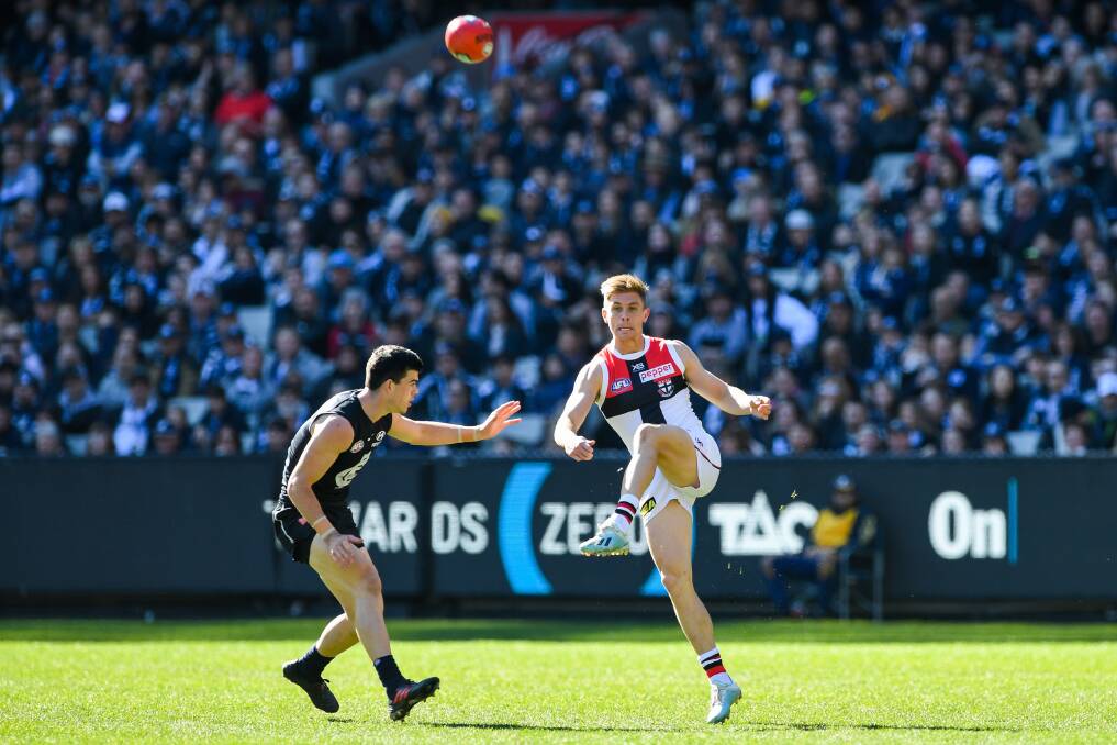 HOME OF FOOTBALL: Supporters watch St Kilda's Seb Ross get a kick away against Carlton at the MCG last season. Picture: Morgan Hancock