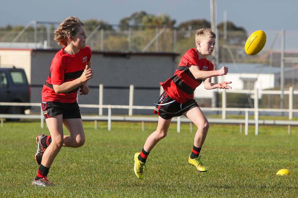 FOOTY, FRIENDS, FUN: Cobden's Eddie Walsh gets a handball away at Bombers' training recently. The Hampden league junior season will be in full swing on Saturday. Picture: Morgan Hancock