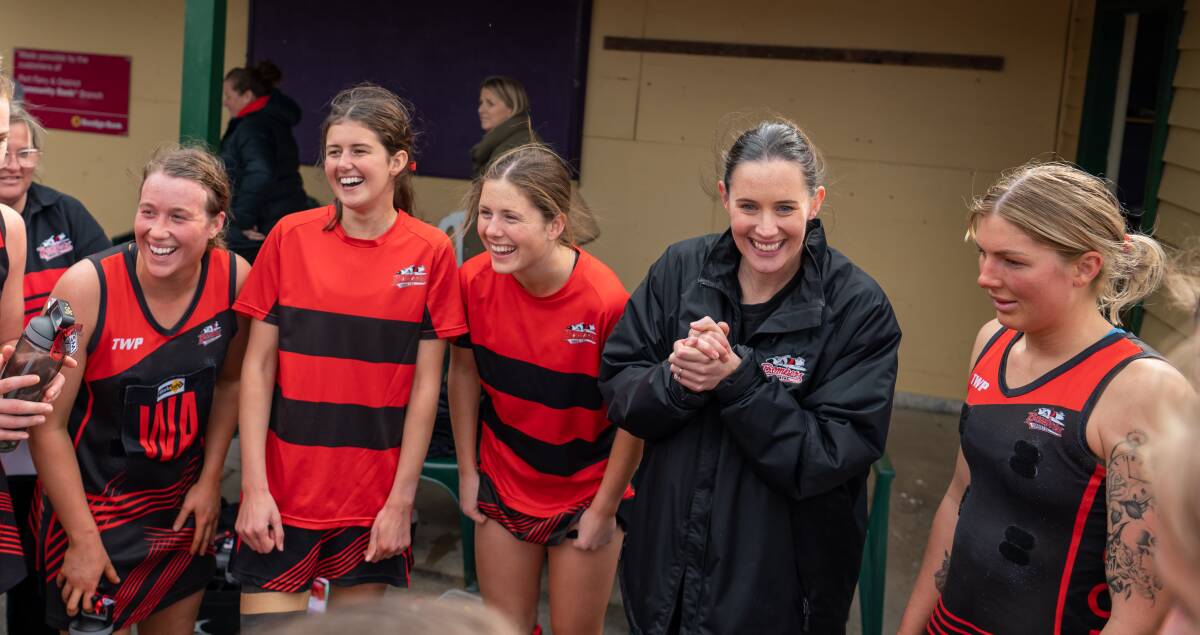 Cobden netballers and coach Sophie Hinkley (second from right) celebrate beating Koroit in the Hampden league preliminary final. Hinkley, who has re-signed as coach, wants to take the team to its first premiership. Picture by Edgar Guerrero 