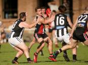 SURROUNDED: Koroit's Frazer Robb tries to evade two Camperdown players on Saturday. Picture: Chris Doheny 