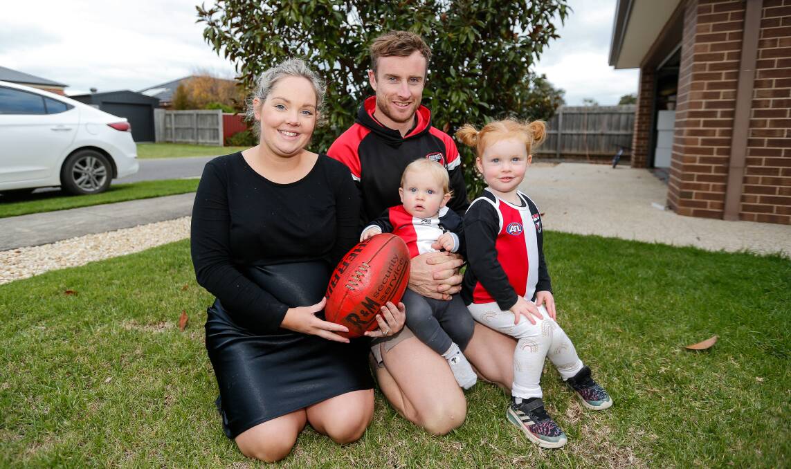 FAMILY BOND: Koroit footballer Brett Harrington with wife Paige and children Huxx and Chili. Picture: Anthony Brady 