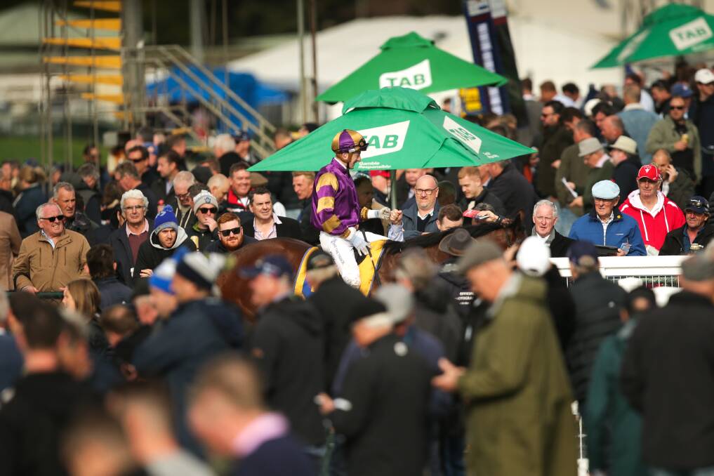 CROWD-PLEASER: Harry Coffey rides through the Warrnambool May Racing Club crowd last week. Picture: Chris Doheny 