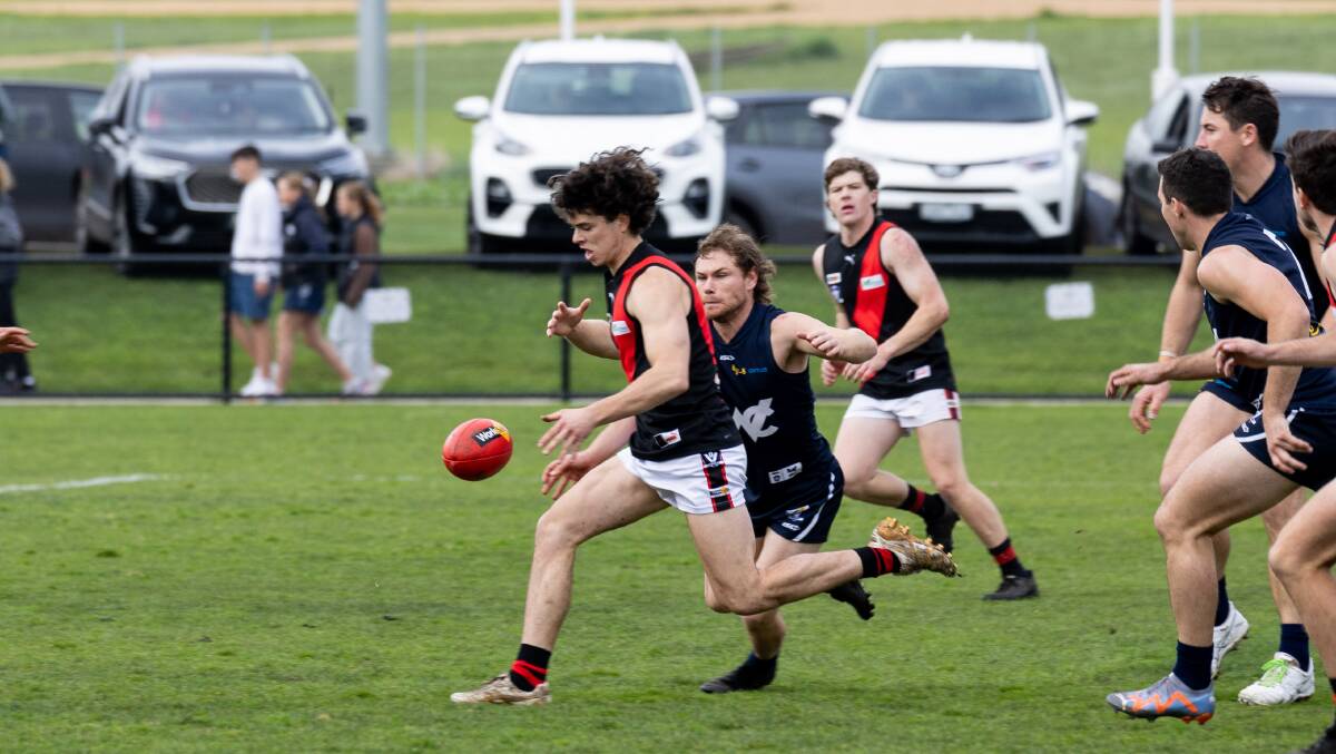 Cobden's Patrick Smith is chased by Warrnambool's Jye Turland. Picture by Anthony Brady