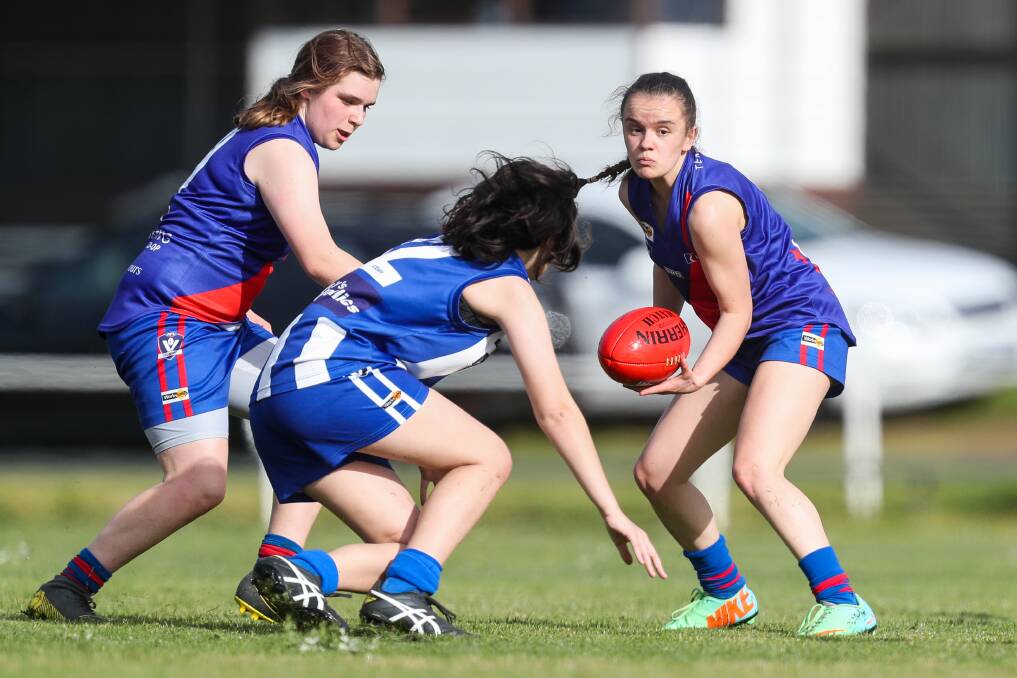 IN TRAFFIC: Jaime Killen prepares to dish out a handpass for Terang Mortlake on Sunday. Picture: Morgan Hancock 