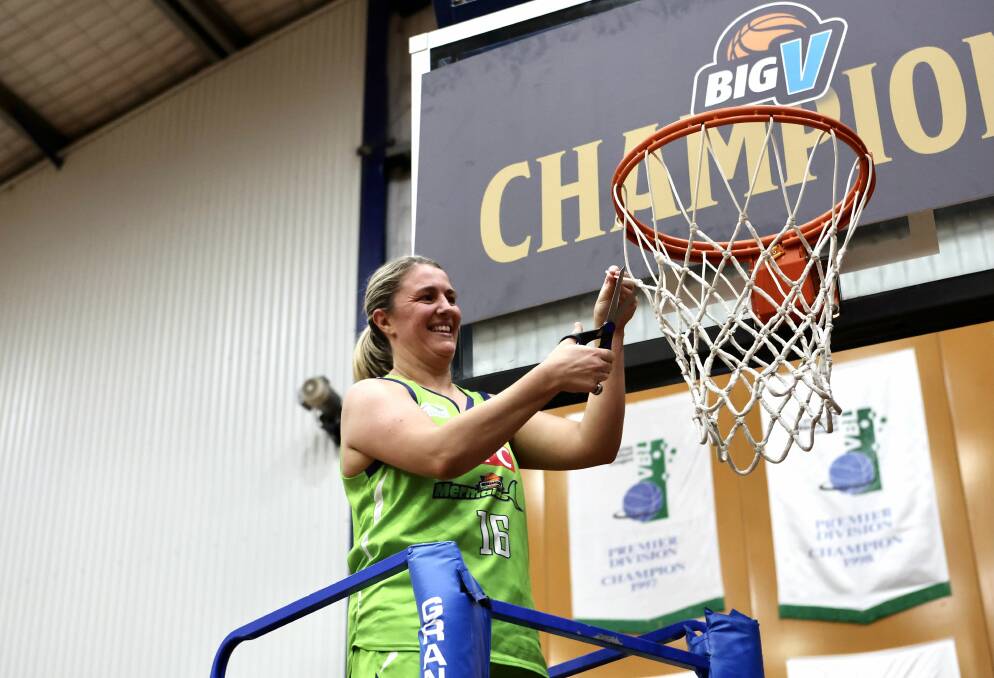 Louise Brown cuts down the championship net after Warrnambool Mermaids won back-to-back Big V titles. Picture by Anthony Brady 