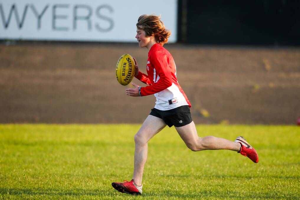 WORKING HARD: Ollie Smith clocks up the kilometres at South Warrnambool under 16 training on Thursday night. Picture: Morgan Hancock 