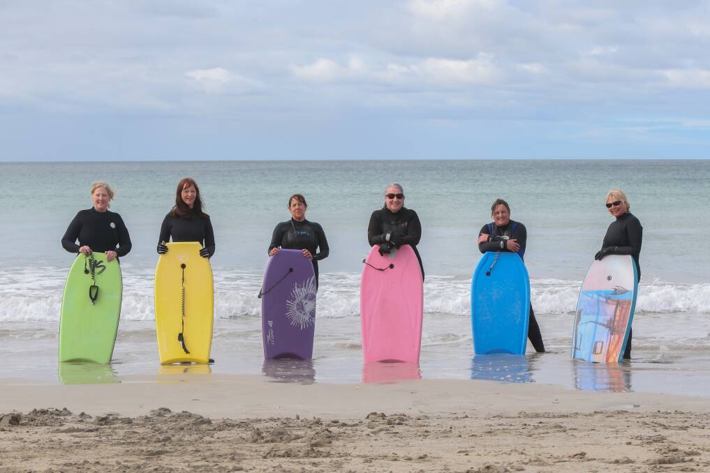 LITTLE COMMUNITY: Bodyboarders Kerry Lee, Karen Henderson, Donna Lumb, Trish Taylor, Jo Wilkinson and Chris Van Kempen hit the Warrnambool surf each morning. Picture: Mark Witte