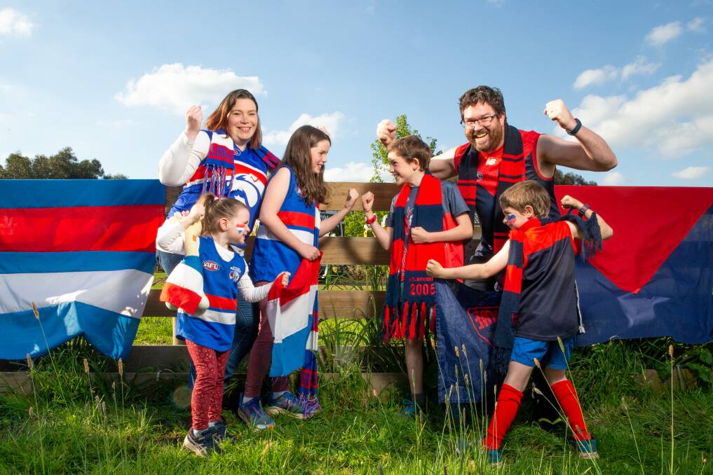 DIVIDED: The McMahon family has opposing football allegiances. Mum Natasha and daughters Grace, 10 and Annie, 4, are Bulldogs and dad Andrew and sons Oliver, 10 and Edmund, 7, are Demons. Picture: Chris Doheny