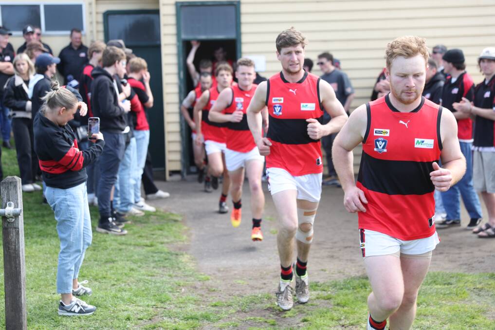 Cobden co-captains Paul Pekin (front) and Jack Hutt lead the Bombers out during their first semi-final against Terang Mortlake in September 2023. Picture by Eddie Guerrero 