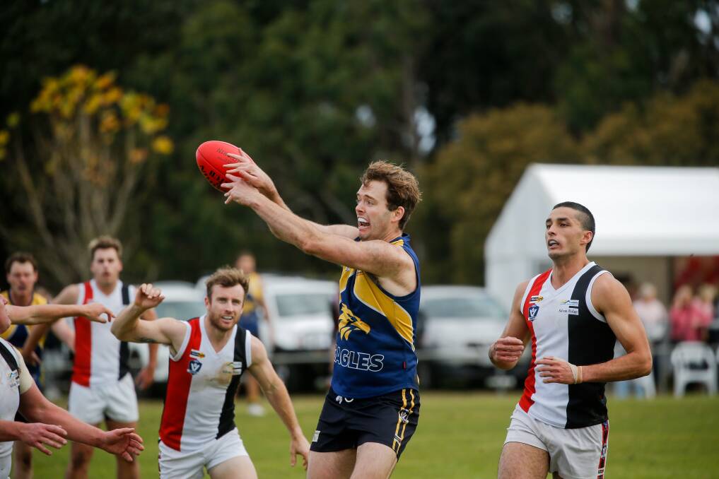 SURROUNDED: North Warrnambool Eagles' Ben Mugavin takes a mark as Koroit players hone in to apply pressure. Picture: Anthony Brady
