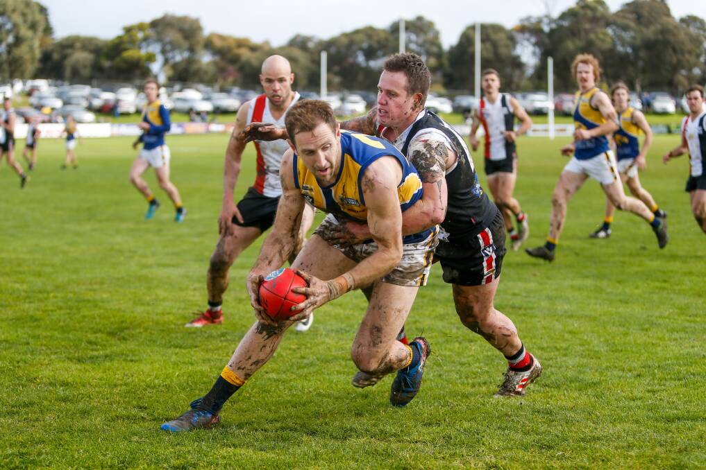 North Warrnambool Eagles' Michael Barlow is tackled by Koroit's Liam Hoy in the 2019 Hampden league grand final. Picture by Morgan Hancock 
