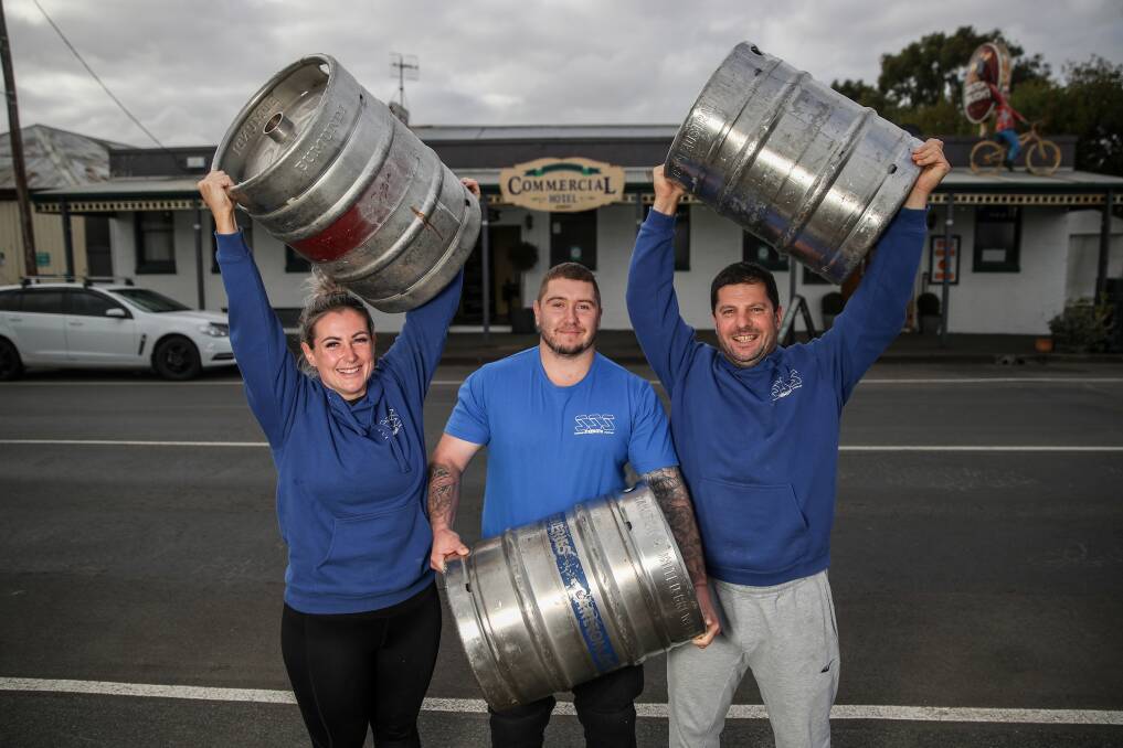 STRONG: Liz Aitken, Luke Featherby and Paul Mammone from South West Strength Sports pose with kegs out the front of the Commercial Hotel, Koroit. Picture: Morgan Hancock