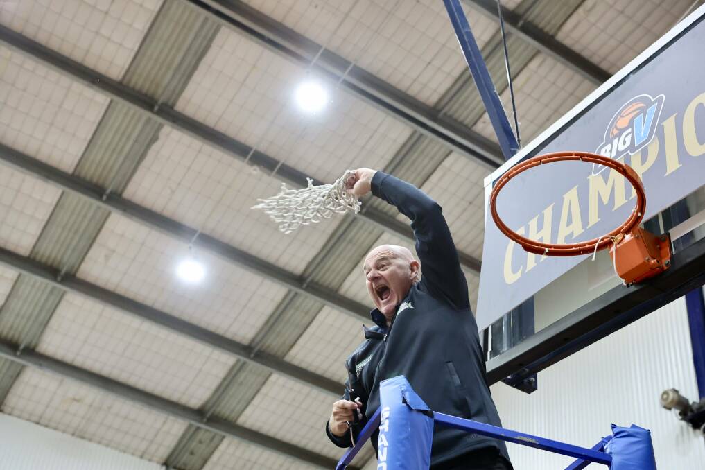 Retiring coach Lee Primmer cuts down the net after Warrnambool Mermaids' grand final success. Picture by Anthony Brady 
