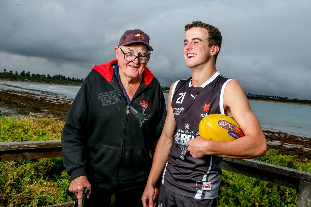 SPECIAL BOND: Ken Timms, who won a flag with Essendon in the 1960s, with his grandson Ned Timms at Warrnambool's beach. Ned has made the NAB League program. Picture: Chris Doheny