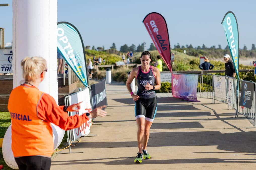 Brooke Gordon smiles as she crosses the Warrnambool foreshore triathlon finish line. Picture by Anthony Brady 