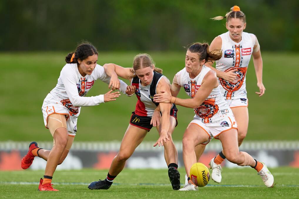 St Kilda's Renee Saulitis tries to beat three GWS Giants opponents during an AFLW game. Picture by Getty Images 