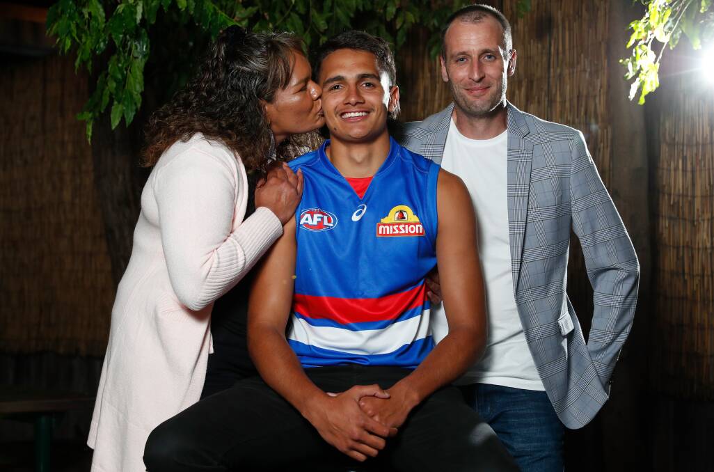 FAMILY TIES: Proud parents Alice Ugle and Aaron Hagan with son Jamarra Ugle-Hagan on AFL draft night last year. Picture: Getty Images 