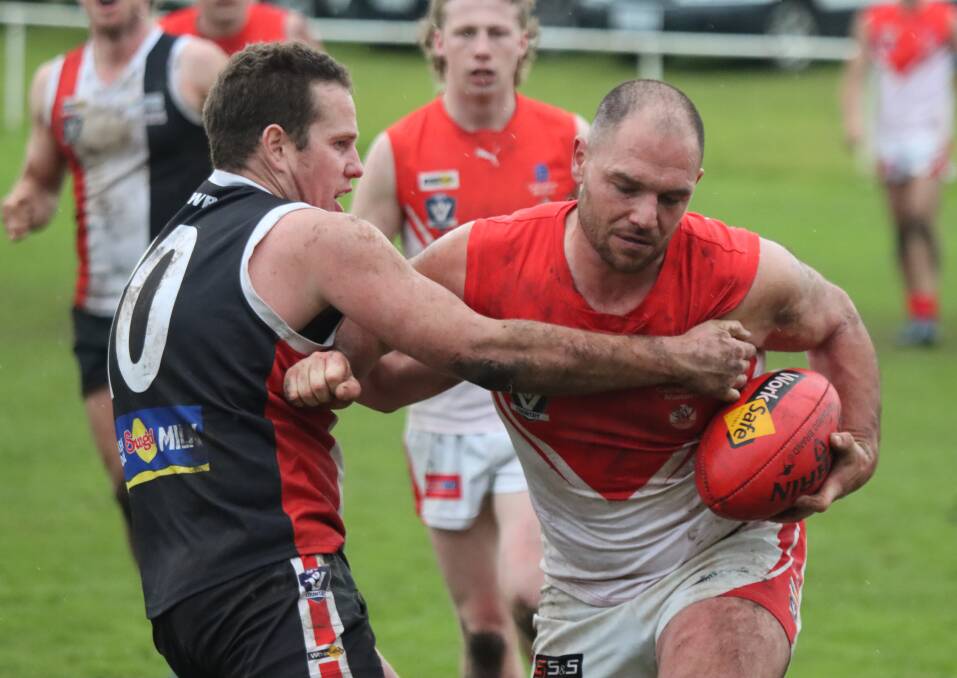 GOTCHA: Koroit captain Liam Hoy wraps South Warrnambool's Peter Doukas up in a tackle. Picture: Justine McCullagh-Beasy 