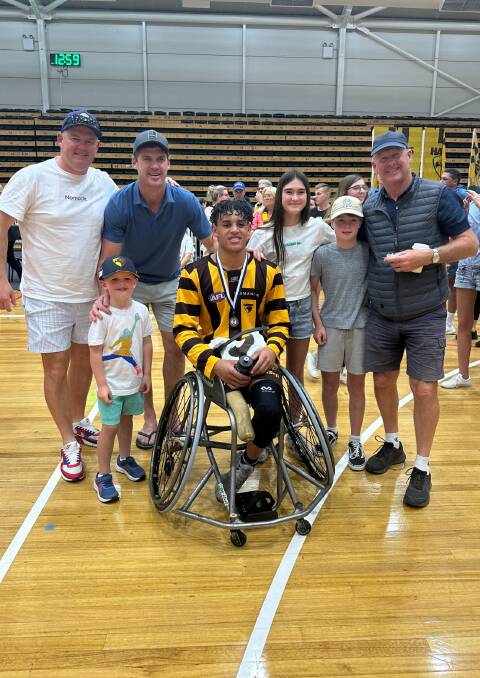 Hawthorn premiership player Jaylen Brown (centre) with dad Matt, brother Tommy, uncle Jonathan, cousins Olivia and Jack and grandfather Brian. Supplied picture 