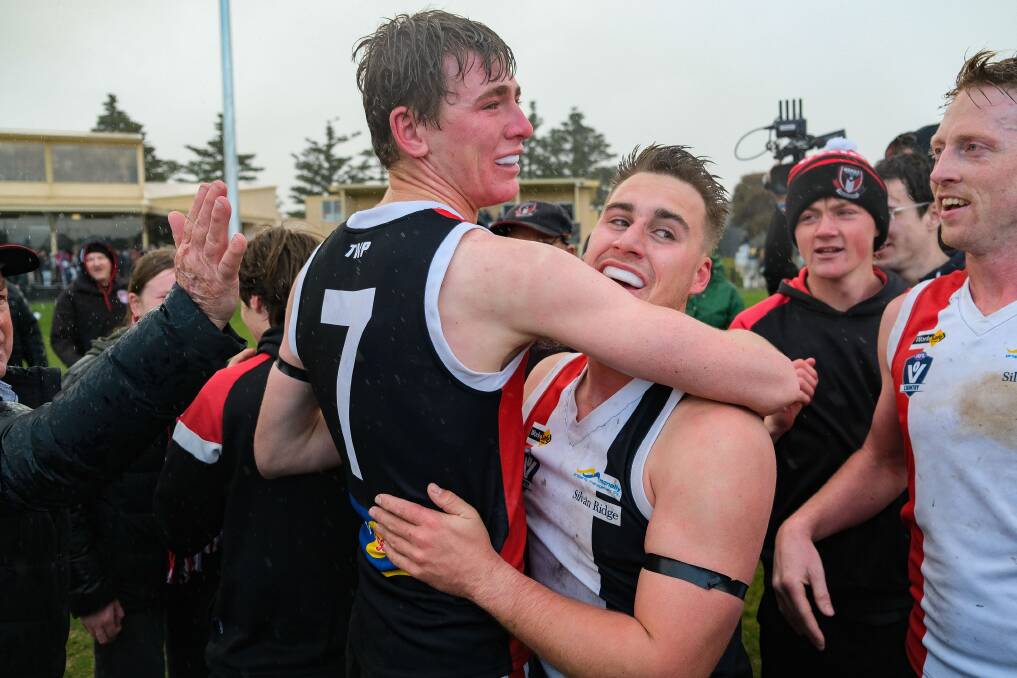 Tom Baulch and Frazer Robb, who also played in his first flag, embrace after the siren. Picture by Chris Doheny 