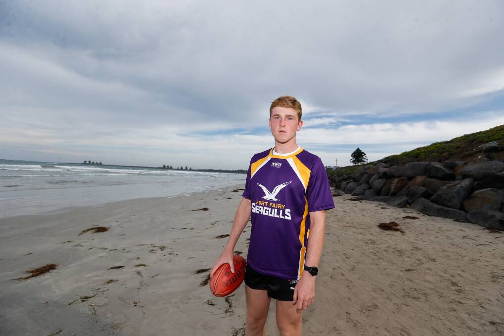 CLUB PRIDE: Oscar Pollock loves wearing Port Fairy's famed purple and gold. Picture: Anthony Brady 