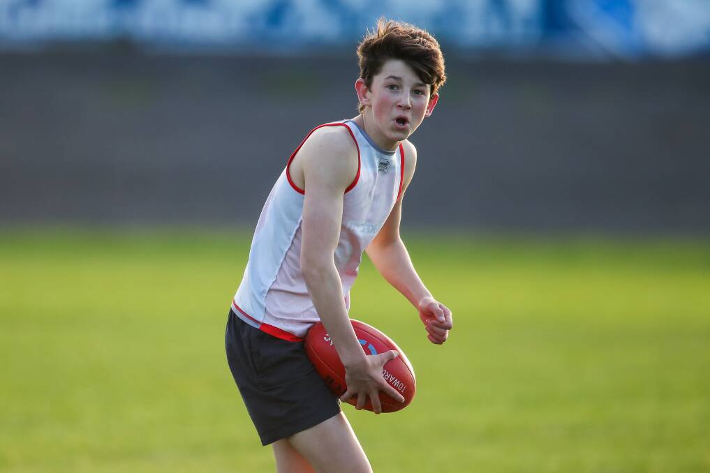 FOCUSED: Ryan Lucas looks for a teammate to kick to during South Warrnambool under 16 training on Thursday. Picture: Morgan Hancock 